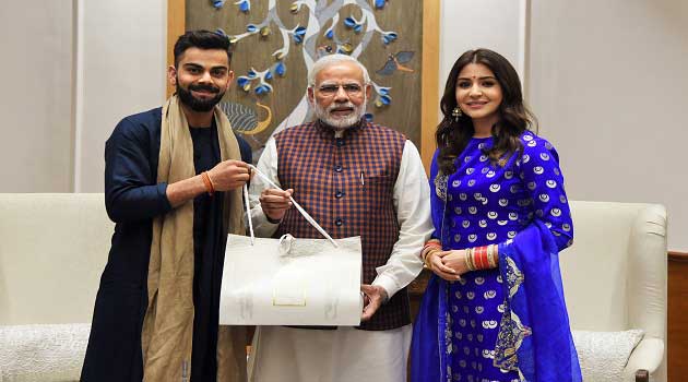 Indian Cricket Team Captain Virat Kohli and actor Anushka Sharma with Prime Minister Narendra Modi, in New Delhi on December 20, 2017.