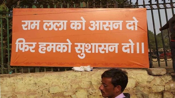 VHP supporters put up banners demanding Ram Temple in Ayodhya as they attended what the Hindu outfit called a "Dharma Sabha" or a religious congregation in New Delhi, on December 9, 2018. Photo by Nadeem Ahmad Kazmi.