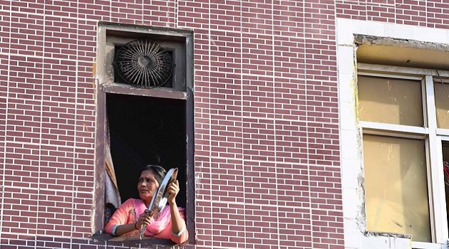 Woman banging steel utencils during Janta Curfew on March 22, 2020 in solidarity with the fight against Coronavirus